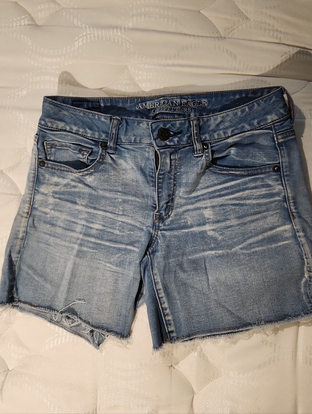 American Eagle Outfitters Light Blue Denim Shorts with Frayed Hem.